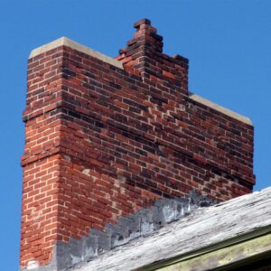 a large masonry chimney that is looking damaged